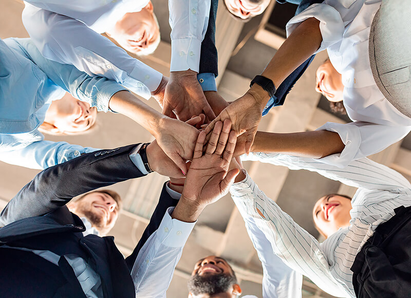 Büroteam legt Hände zusammen